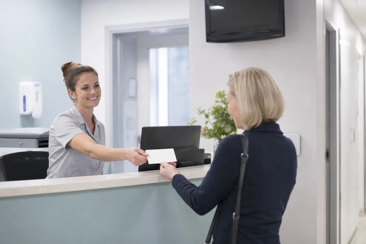 Crowded outpatient waiting area during an overbooked clinic session