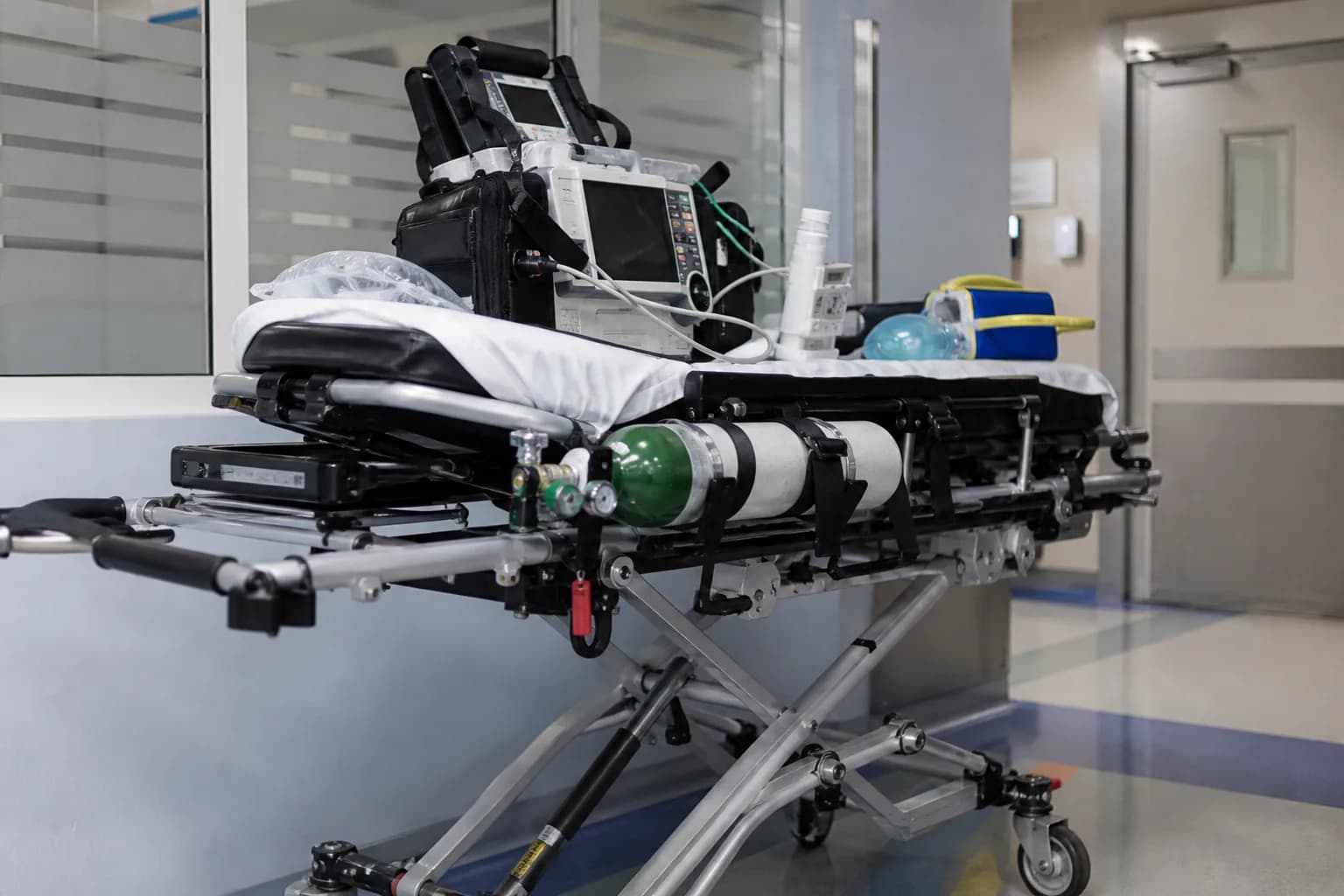 Resuscitation bay prepared during the pre-alert window with role-assigned tasks and a provisional patient record open
