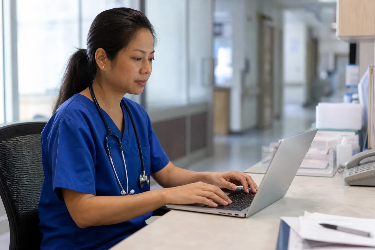 Nurse validating digitally recorded patient vital signs