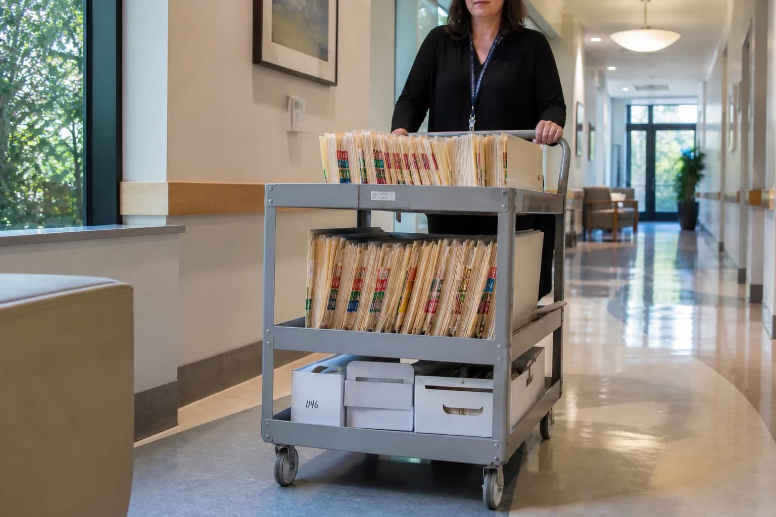 Hospital administrator compiling registration documents for the state health authority